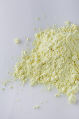 purified sulfur powder on a white acrylic background