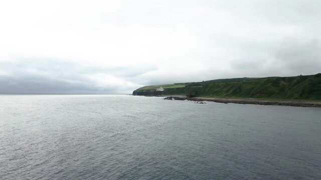 Distant View Of The Dunbeath Castle On The East Coast Of Caithness In Northern Scotland - low aerial drone (approaching)