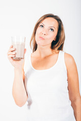 blond woman holding a glass of chocolate milk and smiling