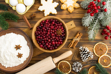 Top view of  ingredients for Christmas cranberry pie on the wooden  background