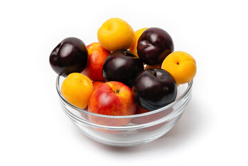 nectarine, peach and plum in a glass bowl on a white background