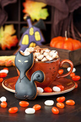 Halloween  time composition with cookies and hot chocolate mug