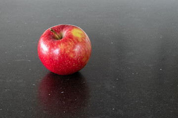An apple a day keeps the doctor away, red apple isolated, black background, healthy life, vitamins