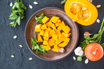 Beautifully chopped pumpkin slices, herbs, and ingredients for the dish. Creative atmospheric decoration