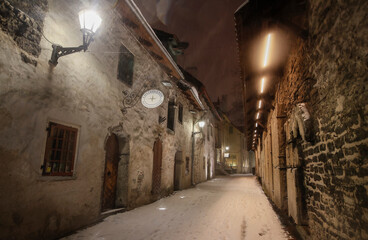 The st Catherine's passage - one of the most picturesque lanes of Old Tallinn and Unesco cultural heritage site at the heavy winter snowfall night