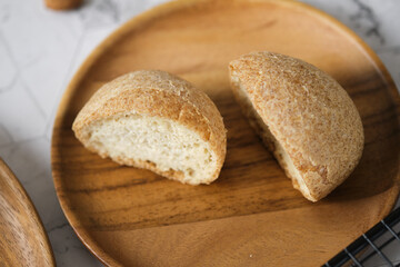 Gluten free Keto bread. Homemade ketogenic buns with sesame seeds. set on white cafe table.