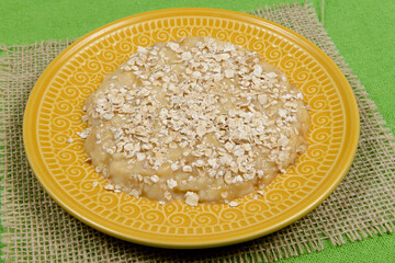 mashed banana with oats on yellow plate