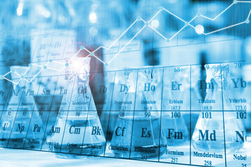 Chemical beaker in laboratory with atomic chart