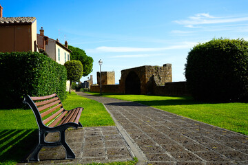 Fototapeta na wymiar Empty bench on a sunny day in Tuscania, Viterbo, Lazio