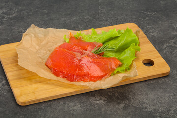 Sliced salmon fillet served rosemary