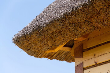 Detail of traditional thatched roof from straw or reed on sunny summer day