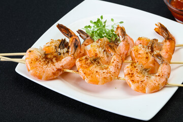 Grilled prawn skewer with sauce