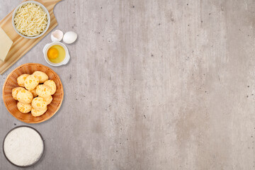 Typical brazilian cheese buns in a basket with ingredients and copy space