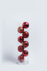 red Christmas toys in a vase on a white background New Year's layout banner space for text