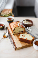 Pie with apricot jam on a wooden board on a light table. View from above.