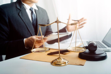 Justice and law concept.Male judge in a courtroom with the gavel, working with, computer and...