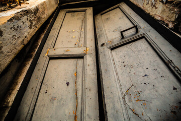 Old wooden door, abandoned house in Italy, bottom view