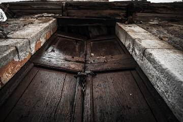 Old wooden door, abandoned house in Italy, bottom view