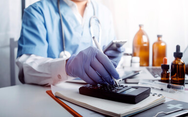 Medical technology concept The doctor works with mobile phones, headphones and tablets. Digital laptop Pressing the calculator in the modern office at the hospital in the morning