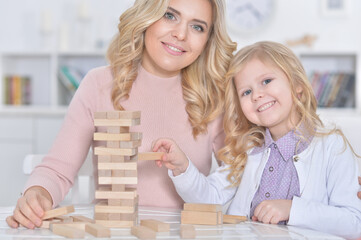 little girl and her mother playing