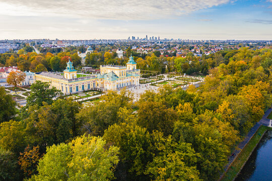 Autumn in Wilanow palace garden, Warsaw distant city center aerial view in the background