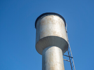 Old metal water tower In Sunny Day In Countryside In Russia In Summer.