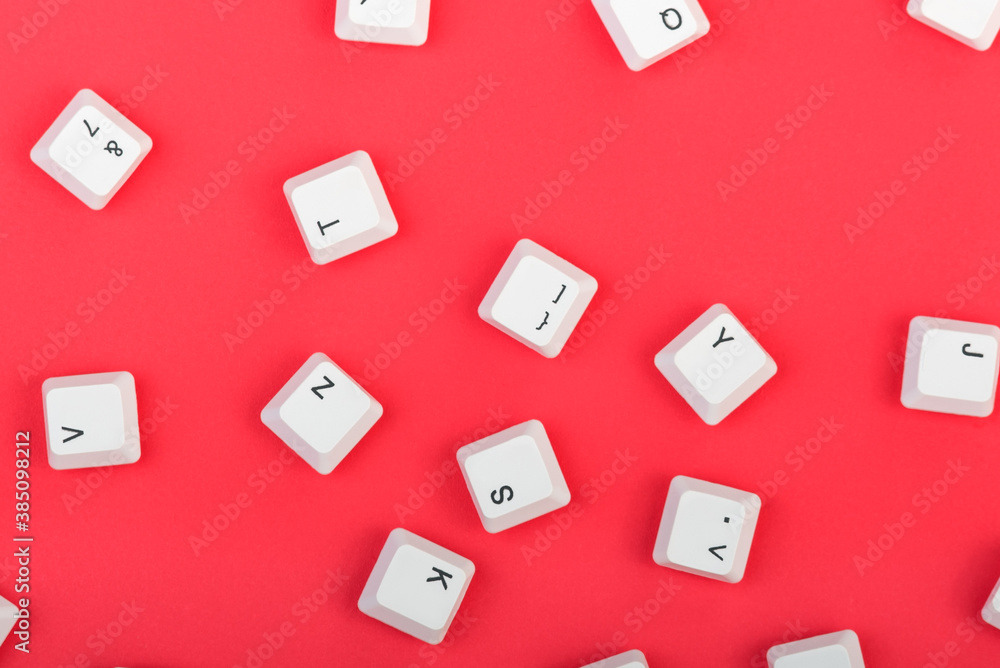 Fototapete keyboard keys isolated. white keyboard keys on red background. top view. close up