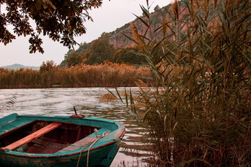 Naklejka na ściany i meble Romantic autumn background, Boat in the river, 