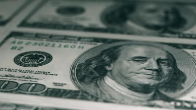 Close-up shot in macro lens from american one hundred dollars banknote. An Abstract of One Hundred Dollar Bills with Narrow Depth of Field. Concept of crisis and savings or bribe