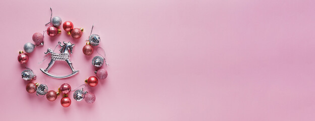 A lot of Christmas balls of pink color.