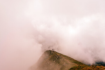 Time after the rain on the top of Gutyn Tomnatyk mountain, mystical fog and white clouds in the mountains, the beauty of the Montenegrin ridge.