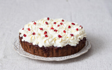 Honey cake with mascarpone cream and pomegranate seeds