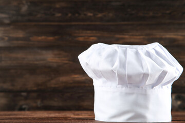 Chef hat on wooden background