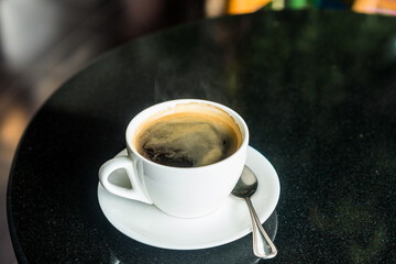 hot black coffee on table in cafe