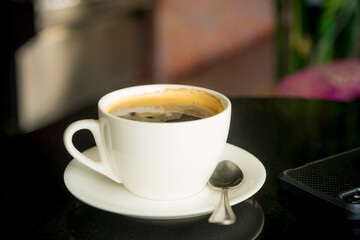 hot black coffee on table in cafe