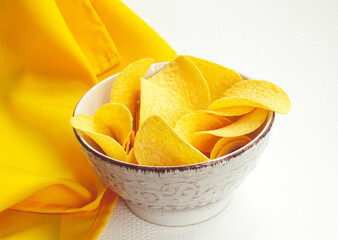 Crispy potato chips in a vintage bowl on white