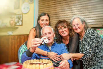 Elderly man celebrates 90th birthday hugged by his daughters at home