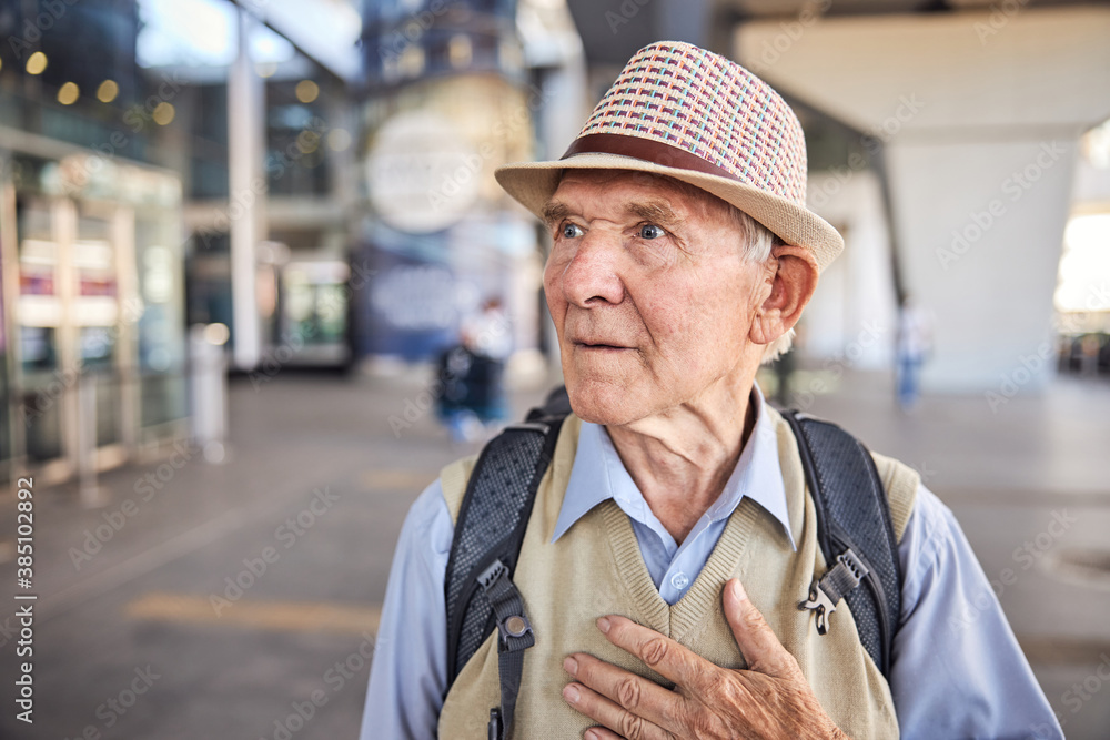 Wall mural Worried male pensioner staring fixedly into the distance