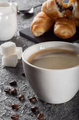 Fresh brewed Americano coffee with foam with mini croissants. Coffee with chocolate croissants