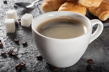 Fresh brewed Americano coffee with foam with mini croissants. Coffee with chocolate croissants