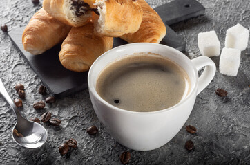 Fresh brewed Americano coffee with foam with mini croissants. Coffee with chocolate croissants