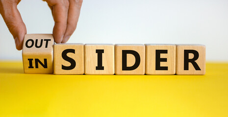 Hand turns a cube and changes the expression 'insider' to 'outsider' or vice versa. Beautiful...