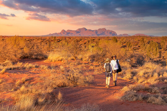 Northern Territory, Australia - Hikers in the Australian outback admiring the spectacular landscape.