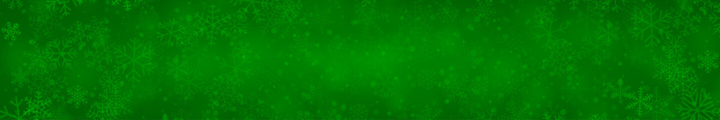 Christmas banner of snowflakes of different shapes, sizes and transparency on green background