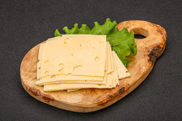Sliced yellow cheese over board