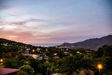 night panoramic view of the mountain village and blue sky with stars