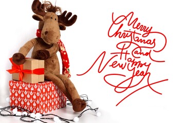 Christmas card. Merry Christmas and happy New year 2021. Text with Christmas evergreen branches, Christmas toys and gifts on a white background