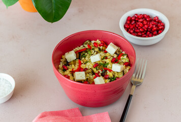 Bulgur with cheese, pepper, eggplant and pomegranate. Healthy eating. Vegetarian food. Diet.