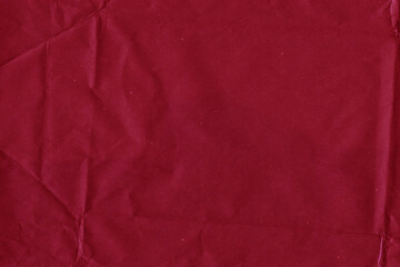 Fototapeta premium Red vintage and old looking crumpled paper background. Retro cardboard texture. Grunge paper for drawing. Ancient book page. Present wrapping.