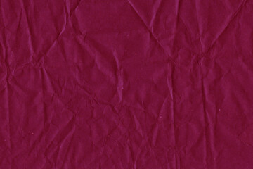 Red vintage and old looking crumpled paper background. Retro cardboard texture. Grunge paper for drawing. Ancient book page. Present wrapping.